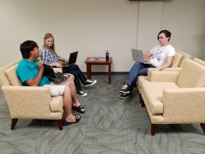 Image of three WIPPS interns at work on a project.